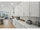 Spacious kitchen featuring white cabinets, sleek countertops, modern appliances, and plenty of natural light at 750 Sand Pine Ne Dr, St Petersburg, FL 33703