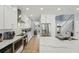 Bright, modern kitchen with stainless steel appliances, white cabinets, and an island with a breakfast bar at 750 Sand Pine Ne Dr, St Petersburg, FL 33703