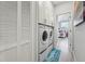 Convenient laundry area equipped with a washer, dryer, storage, and easy access to the bedroom at 750 Sand Pine Ne Dr, St Petersburg, FL 33703
