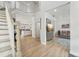 Open floor plan featuring light wood floors, staircase, living room and kitchen at 750 Sand Pine Ne Dr, St Petersburg, FL 33703