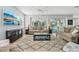 Sun-filled living room featuring neutral tones, large windows and access to the pool area at 750 Sand Pine Ne Dr, St Petersburg, FL 33703