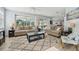 Spacious living room featuring neutral tones, large windows and access to the pool area at 750 Sand Pine Ne Dr, St Petersburg, FL 33703