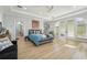 Bright main bedroom with tray ceiling, french doors, and neutral decor at 750 Sand Pine Ne Dr, St Petersburg, FL 33703