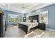 Spacious main bedroom featuring a large bed with a ceiling fan and multiple windows offering natural light at 750 Sand Pine Ne Dr, St Petersburg, FL 33703