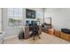 Well-lit office featuring desk, computer, and storage cabinets under two windows at 750 Sand Pine Ne Dr, St Petersburg, FL 33703