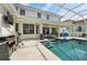 Inviting pool area with grill and shaded seating, ideal for outdoor entertaining and leisure at 750 Sand Pine Ne Dr, St Petersburg, FL 33703