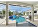 Outdoor pool area features a basketball hoop, grill, and comfortable lounge seating under a screened enclosure at 750 Sand Pine Ne Dr, St Petersburg, FL 33703
