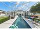 Stunning pool with a long narrow design and screened enclosure offers a private outdoor oasis at 750 Sand Pine Ne Dr, St Petersburg, FL 33703