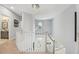 Bright staircase with railing leading to second story overlooking foyer with chandelier at 750 Sand Pine Ne Dr, St Petersburg, FL 33703