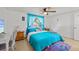 Bedroom with a ceiling fan, natural light, and turquoise colored bedding at 7714 Bayleaf Dr, Hudson, FL 34667