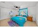 Comfortable bedroom with a ceiling fan, and bright blue decor for a beachy atmosphere at 7714 Bayleaf Dr, Hudson, FL 34667
