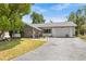 Inviting single-story home showcasing a stone facade, landscaped front yard, and paved driveway at 7714 Bayleaf Dr, Hudson, FL 34667