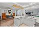 Well-lit kitchen featuring modern appliances, white cabinets, and an open layout to the adjacent living area at 7714 Bayleaf Dr, Hudson, FL 34667