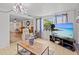 Inviting living room with comfortable seating, large windows, and large flat screen tv at 7714 Bayleaf Dr, Hudson, FL 34667