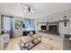 Bright living room with a brick fireplace, large windows, and stylish decor at 7714 Bayleaf Dr, Hudson, FL 34667