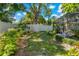 Spacious backyard featuring a well-maintained lawn, privacy fence, and screened-in pool area at 785 Hickory Ln, Palm Harbor, FL 34683