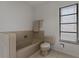 Bathroom features soaking tub, neutral tiling and private window at 785 Hickory Ln, Palm Harbor, FL 34683
