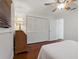 Bedroom showcasing wood floors, large closets and ceiling fan at 785 Hickory Ln, Palm Harbor, FL 34683