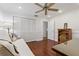Comfortable bedroom featuring hardwood floors, ample closet space, and a ceiling fan at 785 Hickory Ln, Palm Harbor, FL 34683