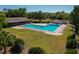 Large community pool with ample seating and a surrounding deck, perfect for relaxation and recreation at 785 Hickory Ln, Palm Harbor, FL 34683