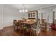 Dining room with hardwood floors, traditional furniture, and mirrors creating a bright and open space at 785 Hickory Ln, Palm Harbor, FL 34683