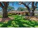 Charming single-story home featuring a well-manicured lawn and mature trees at 785 Hickory Ln, Palm Harbor, FL 34683