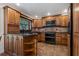 Well-equipped kitchen featuring custom wood cabinetry and modern appliances at 785 Hickory Ln, Palm Harbor, FL 34683