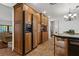 Spacious kitchen featuring wood cabinets and shelving, tile flooring, and stainless steel appliances at 785 Hickory Ln, Palm Harbor, FL 34683