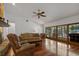 Bright and spacious living room with hardwood floors, large windows, and comfortable seating at 785 Hickory Ln, Palm Harbor, FL 34683