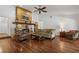 Open living room with hardwood floors, stone fireplace, and comfortable seating at 785 Hickory Ln, Palm Harbor, FL 34683
