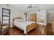 Main bedroom features wood flooring, two windows and an overhead ceiling fan at 785 Hickory Ln, Palm Harbor, FL 34683