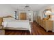 Main bedroom features wood flooring, an overhead fan and ensuite access at 785 Hickory Ln, Palm Harbor, FL 34683
