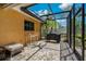 Screened patio featuring a built-in grill, bench, and ceiling fan for outdoor living at 785 Hickory Ln, Palm Harbor, FL 34683