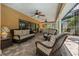 Outdoor covered patio with wicker furniture and ceiling fans overlooking a pool at 785 Hickory Ln, Palm Harbor, FL 34683
