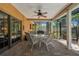 Covered patio with dining table, ceiling fan, overlooking the screened-in pool area at 785 Hickory Ln, Palm Harbor, FL 34683