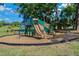 Community playground with slides, climbing structures, and a soft landing surface for children to play safely at 785 Hickory Ln, Palm Harbor, FL 34683