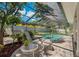 Inviting pool area with lush landscaping, perfect for relaxing and entertaining outdoors at 785 Hickory Ln, Palm Harbor, FL 34683