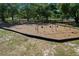 A set of swings sits on a bed of mulch surrounded by green grass and mature trees at 785 Hickory Ln, Palm Harbor, FL 34683