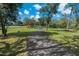 Scenic walking path winding through the community, surrounded by mature trees and verdant green space at 785 Hickory Ln, Palm Harbor, FL 34683