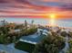 Breathtaking oceanfront home with private beach access and lush tropical landscaping at sunset at 8030 Manasota Key Rd, Englewood, FL 34223