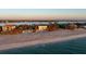 A breathtaking waterfront view of luxury homes along a sandy beach at 8030 Manasota Key Rd, Englewood, FL 34223