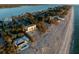 Aerial view of beachfront homes, lush landscaping, and the Gulf of Mexico at 8030 Manasota Key Rd, Englewood, FL 34223