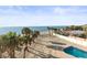 Aerial view of the home's backyard pool and access to sandy beach and Gulf at 8030 Manasota Key Rd, Englewood, FL 34223