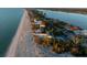 Stunning aerial view of beachfront homes along the coast with lush tropical landscaping at 8030 Manasota Key Rd, Englewood, FL 34223