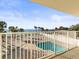 Beautiful balcony view featuring a pool and ocean with palm trees on a sunny day at 8030 Manasota Key Rd, Englewood, FL 34223