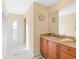 Bathroom featuring a vanity with wooden cabinets and access to the outside at 8030 Manasota Key Rd, Englewood, FL 34223