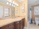 Bathroom featuring dark wood cabinets, shower, and decorative wall art at 8030 Manasota Key Rd, Englewood, FL 34223