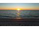 Beautiful beach view featuring a sunrise over the ocean at 8030 Manasota Key Rd, Englewood, FL 34223