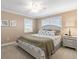 Cozy bedroom with carpet, fan, white furnishings, and bright natural light at 8030 Manasota Key Rd, Englewood, FL 34223