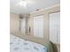 Cozy bedroom with carpet and closets, illuminated by a ceiling fan with lights at 8030 Manasota Key Rd, Englewood, FL 34223